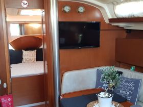 Interior view of a cozy boat cabin featuring comfortable seating and a welcoming atmosphere, perfect for relaxing during your maritime adventures.