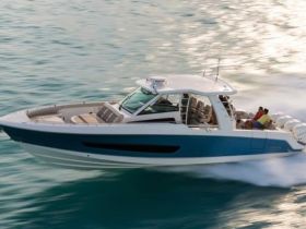 A sleek speedboat glides through the water with guests enjoying the ride, showcasing the thrill of a day on the water.