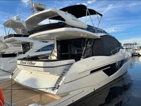 A stunning view of the 'Good Vibes' yacht docked at the marina, showcasing its sleek design and luxurious features.