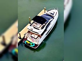 A stunning aerial view of a luxurious yacht docked at the marina, showcasing its sleek design and spacious deck, perfect for relaxation and entertaining.