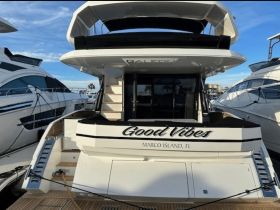 A stunning view of the 'Good Vibes' yacht docked at Marco Island, showcasing its elegant design and inviting atmosphere.