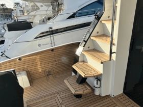 A detailed view of the interior stairs on a luxury yacht, showcasing the elegant design and craftsmanship typical of high-end boating experiences.