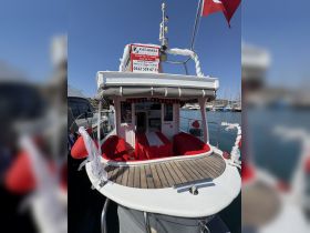 The interior of a boat decorated for a birthday celebration, featuring red seating and a festive atmosphere. Ideal for private tours and special occasions on the water.