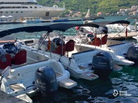 A collection of speedboats docked at a marina, showcasing their sleek designs and Yamaha engines, perfect for exploring coastal waters.