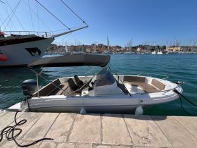 A sleek Atlantic Marine boat docked at a marina, showcasing its modern design against a picturesque waterfront backdrop.