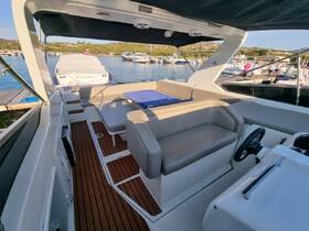 A spacious interior view of a boat's helm and seating area, showcasing comfortable lounging options for guests. Ideal for relaxing while enjoying a day on the water.