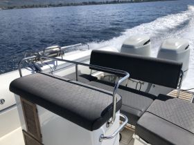 Interior view of a sleek boat seating area, showcasing comfortable seating and a clean design, perfect for enjoying a day on the water.
