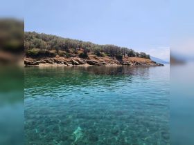 A stunning view of a serene coastline with crystal-clear waters, perfect for exploring the natural beauty of the area.