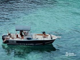 A lively group enjoys a day on the water aboard a charter boat, showcasing fun and relaxation in the beautiful turquoise sea.