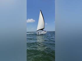 A beautiful sailboat glides through the water under a clear blue sky, showcasing its elegant design and perfect for sailing adventures.