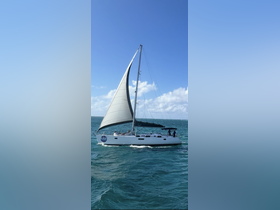 A beautiful sailboat named 'Blue Sky' gracefully sails through turquoise waters, showcasing the perfect day for a sailing adventure.