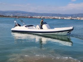 A sleek speedboat glides through calm waters with a person at the helm, showcasing the perfect vessel for thrilling adventures on the sea.