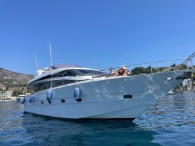 A couple enjoys a sunny day aboard a luxurious yacht, showcasing the perfect setting for relaxation and adventure on the water.
