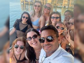 A lively group of friends enjoys a fun day on the water, capturing memories with smiles and sunglasses. Perfect for celebrating special occasions or just enjoying the sun.
