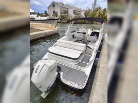 A sleek interior view of a luxury boat showcasing comfortable seating and a modern helm, perfect for a day on the water.
