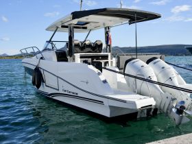 A sleek Cap Camarat boat docked in clear waters, showcasing its modern design and powerful twin engines — perfect for day trips and water adventures.