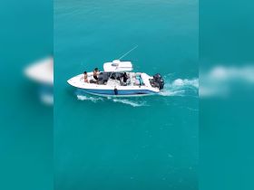 A group enjoys a day on the water aboard a boat, cruising through stunning turquoise waters — perfect for adventure and relaxation.