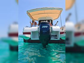 Guests enjoy a sunny day on a boat, showcasing the vibrant turquoise waters and the excitement of on-water activities.