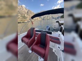 Interior view of a stylish boat helm featuring comfortable seating, perfect for navigating scenic waters.
