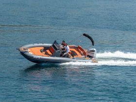 A couple enjoys a thrilling ride on a speedboat, showcasing the excitement of on-water adventures.