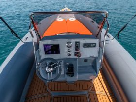 A detailed view of the helm and console area of a modern inflatable boat, showcasing the sleek design and functional layout ideal for navigation.