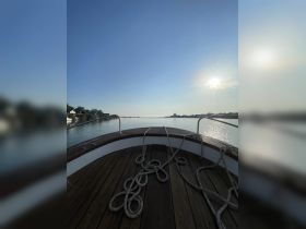 A serene view from the front of a boat, showcasing the calm waters and clear sky, perfect for a peaceful day on the water.