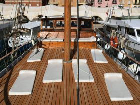 The interior of a boat features spacious lounge seating, perfect for relaxing while enjoying the views. Ideal for leisurely trips on the water.
