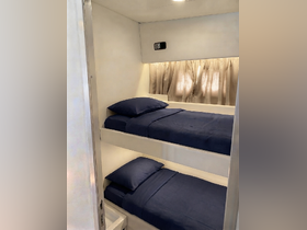 Cozy interior view of a boat cabin featuring bunk beds, perfect for comfortable overnight stays while cruising.