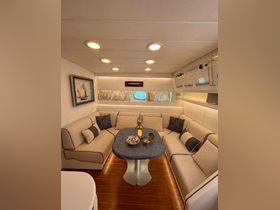 A cozy interior view of a boat's lounge area featuring comfortable seating and a stylish table, perfect for relaxation and socializing while on the water.