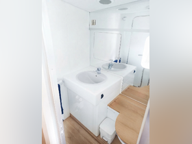 A clean and modern bathroom interior on a boat, featuring a sink and wooden accents, ideal for comfortable cruising experiences.