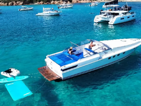 A lively scene featuring guests enjoying a day on the water, with a boat anchored amidst turquoise waters and a floating mat for relaxation and fun.