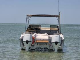 A clear view of a speedboat anchored in shallow waters, showcasing its sleek design and inviting atmosphere for a day on the water.