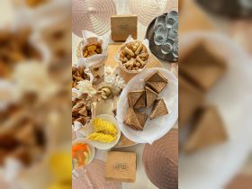 A delightful spread of snacks and refreshments, including sandwiches, spring rolls, and fresh fruit, perfect for enjoying on a boat trip.