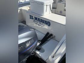 Detailed view of the interior of a sport fishing boat, featuring the engine and storage area, ideal for fishing trips in Cabo San Lucas.