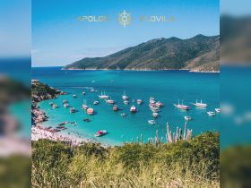A stunning aerial view of a vibrant beach scene with numerous boats anchored in turquoise waters, showcasing a lively atmosphere perfect for island adventures.