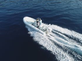 A speedboat glides through deep blue waters, showcasing an exhilarating day on the water with guests enjoying the ride.