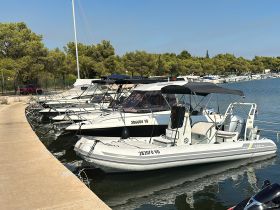 A collection of boats docked at a marina, showcasing various models and styles, perfect for exploring the beautiful waters.