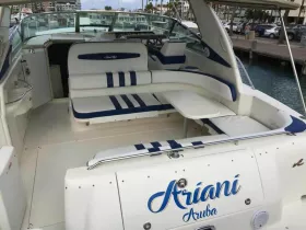 Interior view of a stylish boat cabin featuring comfortable seating, perfect for relaxing during a day on the water.