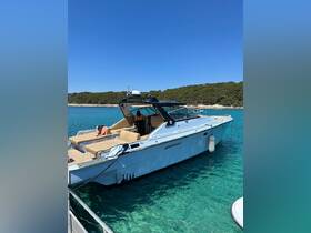 A sleek yacht named Kormoran II docked in crystal-clear waters, showcasing its spacious seating and inviting atmosphere for a perfect day on the water.