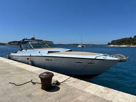 A sleek speedboat docked at the marina, showcasing its elegant design against a clear blue sky and tranquil waters, perfect for day trips and coastal adventures.