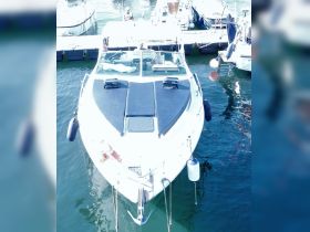 A sleek yacht is docked, showcasing its elegant design and features, perfect for luxury outings on the water.