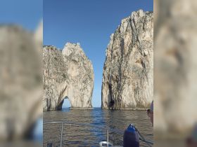 A stunning view of iconic rock formations, known as El Arco, from a boat, showcasing the natural beauty of the coastline — a must-see landmark while exploring the waters.