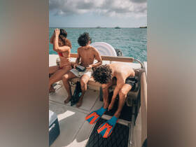 A group prepares for snorkeling on a boat, showcasing excitement and camaraderie as they gear up for an underwater adventure.