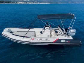 A sleek speedboat glides through clear blue waters, showcasing its modern design and perfect for thrilling water adventures.