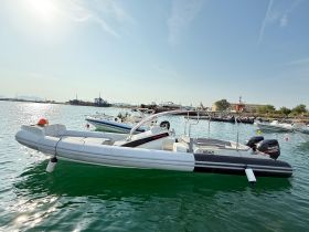 A sleek speedboat named 'ABAZI' docked in calm waters, showcasing its modern design and readiness for adventure.