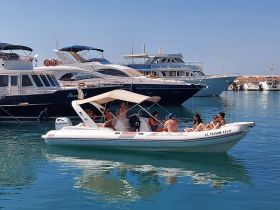 A lively group enjoys their time aboard a boat in a marina, perfect for social gatherings and fun on the water.