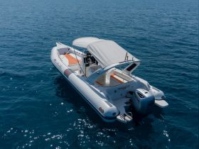 Aerial view of a sleek speedboat cruising through clear blue waters, perfect for thrilling adventures on the open sea.