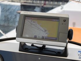Close-up of a Garmin GPS navigation system on a boat, showcasing essential electronics for safe and efficient navigation on the water.