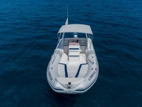A stunning aerial view of a sleek speedboat gliding through clear blue waters, perfect for thrilling adventures on the open sea.