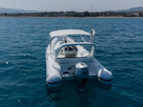 A sleek speedboat captured from the back, gliding through clear waters, perfect for thrilling adventures on the sea.
